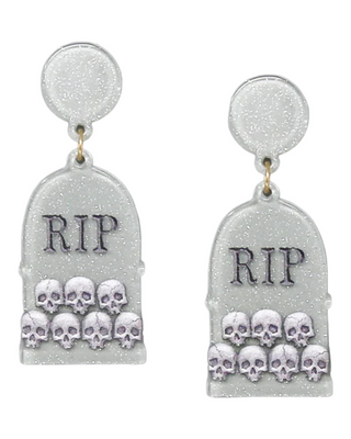 earrings depicting white shimmering tombstones, each with an "RIP" inscription and a group of small, detailed skulls clustered at the bottom