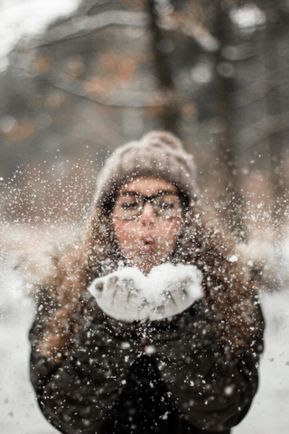 Woman blowing snow. Photo by Darius Krause: