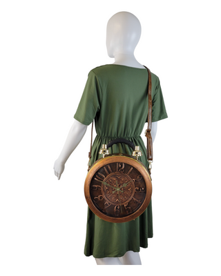 Brown circular shaped handbag/crossbody with working clock face on a mannequin