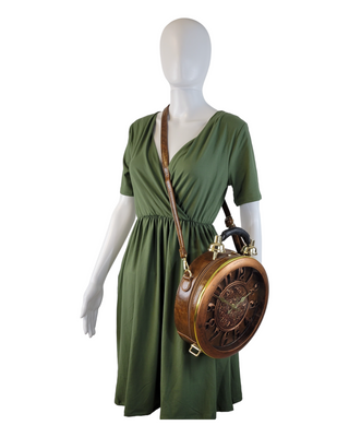 Brown circular shaped handbag/crossbody with working clock face on a mannequin