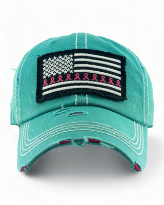 Teal distressed baseball cap featuring an American flag patch with pink breast cancer awareness ribbons on the stripes.