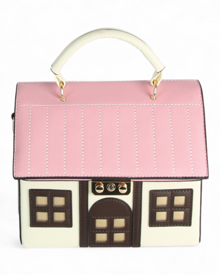 Pink house-shaped handbag with white handle on a white background