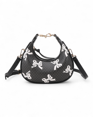 Black handbag with white bow pattern on a white background