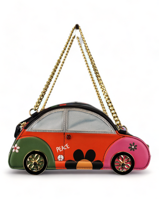 Novelty handbag shaped like a VW Beetle, black with green and pink accents, polka dots, a peace sign, and a gold chain strap.