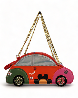 Novelty handbag shaped like a VW Beetle, red with green and pink accents, polka dots, a peace sign, and a gold chain strap.