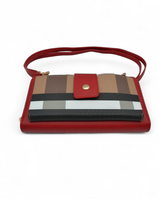 Multicolored striped handbag with a red strap on a white background