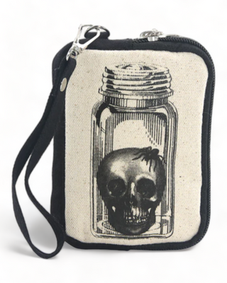 Close-up of a canvas pouch featuring a skull inside a jar print, highlighting the intricate details and print quality