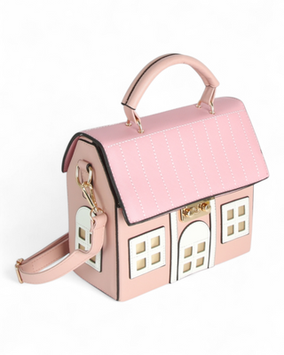 Pink house-shaped handbag with a white background