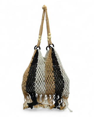 Net bag with woven handle and tassels on a white background