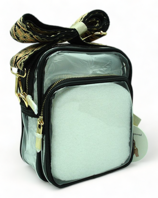 Clear shoulder bag with guitar strap and black trim.