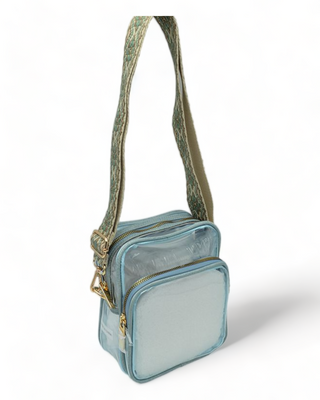 Clear shoulder bag with guitar strap and blue trim.