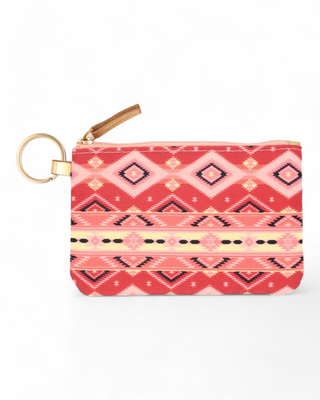 Textile ID holder with a rich tribal pattern in shades of pink and coral, equipped with a gold ring for keys and a clear front pocket for displaying identification cards.