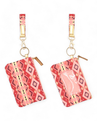 Textile ID holder with a rich tribal pattern in shades of pink and coral, equipped with a gold ring for keys and a clear front pocket for displaying identification cards.