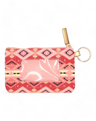 Textile ID holder with a rich tribal pattern in shades of pink and coral, equipped with a gold ring for keys and a clear front pocket for displaying identification cards.