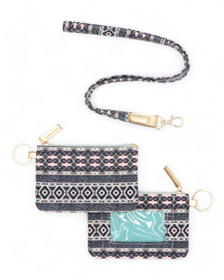 Textile ID holder with a rich tribal pattern in shades of blue,  pink and coral, equipped with a gold ring for keys and a clear front pocket for displaying identification cards.