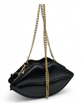 Black handbag with a gold chain strap on a white background