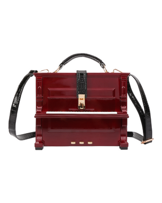 An elegant red structured handbag with a glossy finish and crocodile texture, featuring gold-tone hardware accents and a detachable shoulder strap.