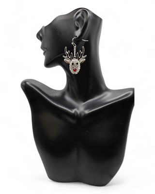 A sparkling reindeer dangle earring displayed on a black mannequin bust. The reindeer has rhinestone detailing, with large antlers and a red nose, creating a fun and festive look for the holidays.