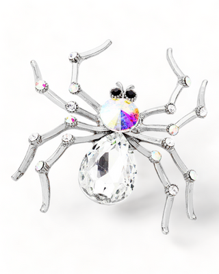Clear spider-shaped brooch with iridescent gemstone accents and glossy legs.