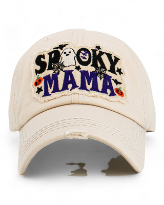 Ivory Distressed caps with 'Spooky Mama' patch featuring a ghost, bats, and pumpkins