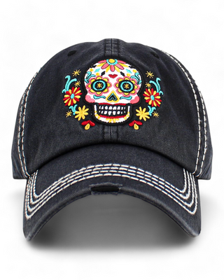 black baseball cap featuring a colorful embroidered sugar skull with floral designs.