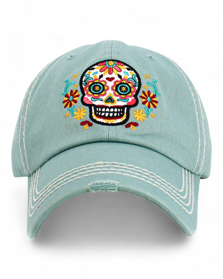 light blue baseball cap featuring a colorful embroidered sugar skull with floral designs.
