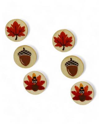 Wooden stud earrings with acorn, maple leaf, and turkey designs in autumn colors.