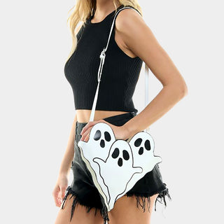 A model wearing a black crop top and black shorts, showcasing the white ghost crossbody bag with three friendly ghost designs, 