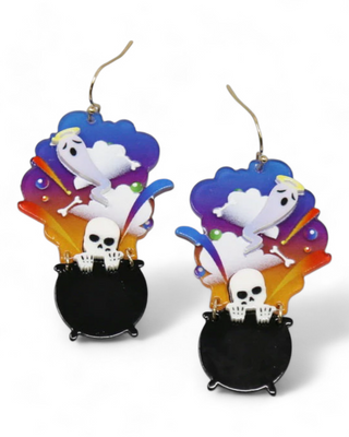 Colorful Halloween earrings featuring a black cauldron with a skeleton popping out, surrounded by vibrant smoke with ghosts, bones, and colorful accents