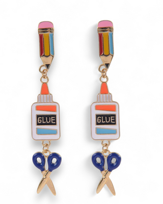 Earrings designed like glue bottles and scissors on a white background