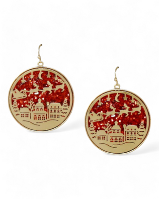 Round earrings with Santa and reindeer cutout scene over a glittery background