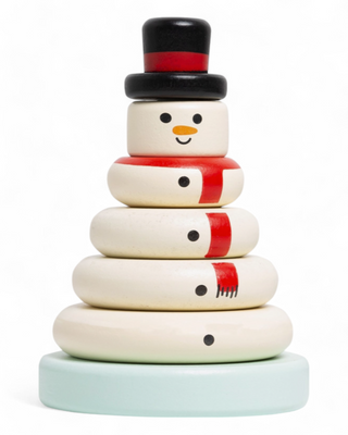 A wooden snowman stack toy in a clear box with red packaging, featuring stackable rings painted with a snowman design, including a black top hat and red scarf.