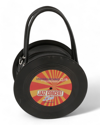 A circular handbag designed to look like a vinyl record with a colorful "Jazz Concert Live" label in red, yellow, and orange tones, featuring black handles and a zipper closure.